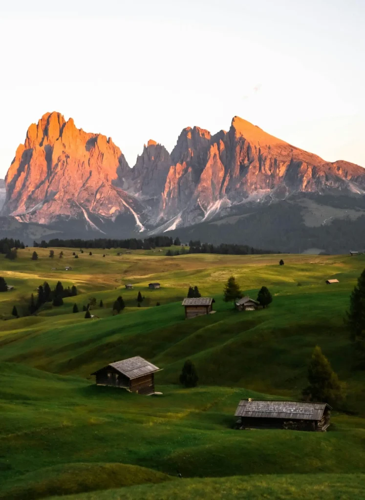 Sunset over the pink-hued Dolomites, casting golden light across the peaks