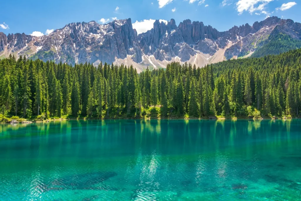 Lake Carezza reflecting the Latemar mountains at sunrise